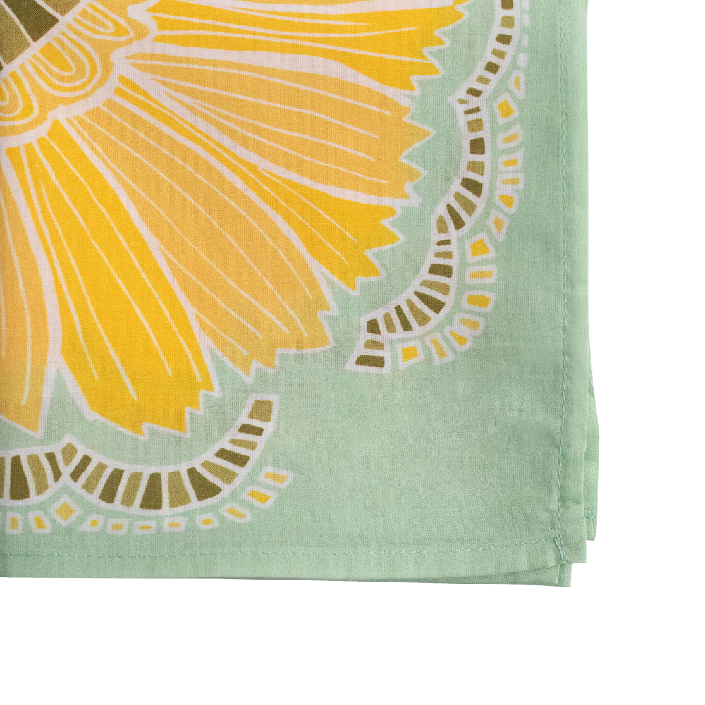 Close-up of the No. 044 Hazel Bandana showing its yellow floral print, olive leaves, and light green border.