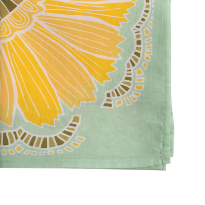 Close-up of the No. 044 Hazel Bandana showing its yellow floral print, olive leaves, and light green border.
