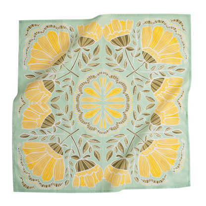 No. 044 Hazel Bandana laid flat, featuring bright yellow flowers and olive leaves on a light green background.