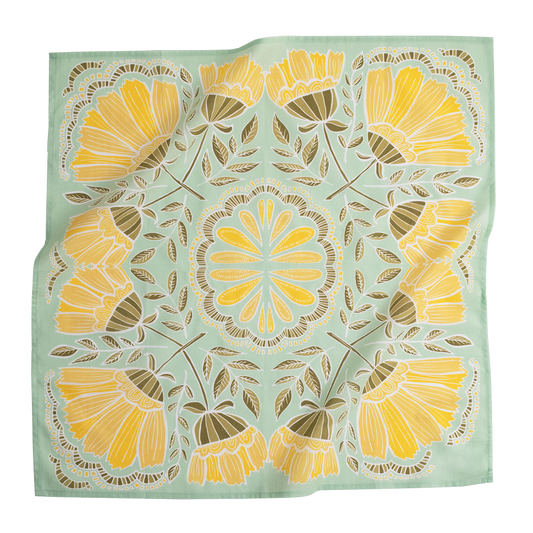 No. 044 Hazel Bandana laid flat, featuring bright yellow flowers and olive leaves on a light green background.