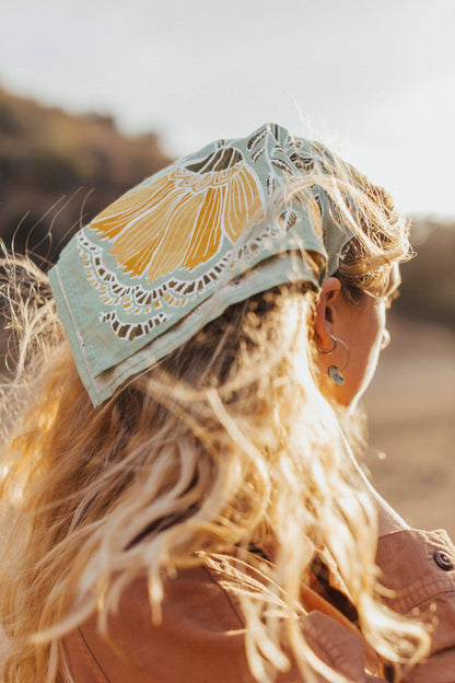 Woman wearing the No. 044 Hazel Bandana tied over her hair as a headscarf.