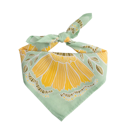 No. 044 Hazel Bandana folded and tied to display its light green, yellow, and olive botanical pattern.
