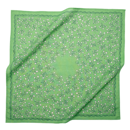 Kelly green cotton bandana with a cream calico floral pattern and decorative border shown loosely draped.