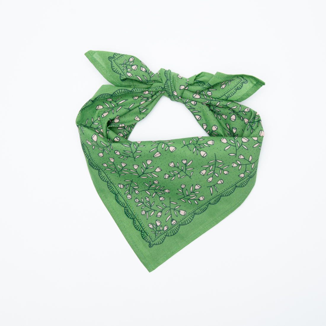 Kelly green floral Posey Bandana folded into a triangle and tied at the top.