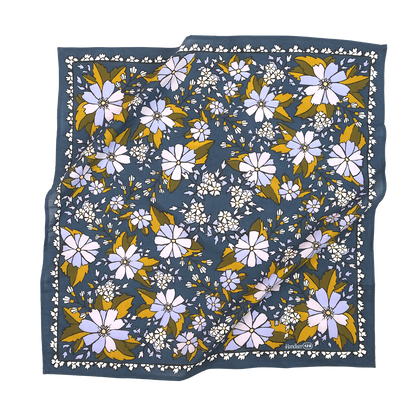 No. 129 Chicory Bandana laid flat, featuring lilac and purple flowers with muted green and golden leaves on a dark blue background.