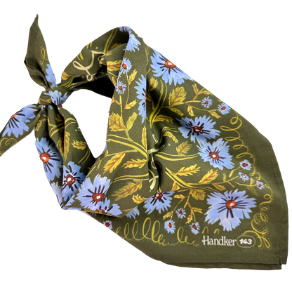 No. 143 Clara bandana tied into a scarf shape, featuring an olive green base with periwinkle floral and botanical print.