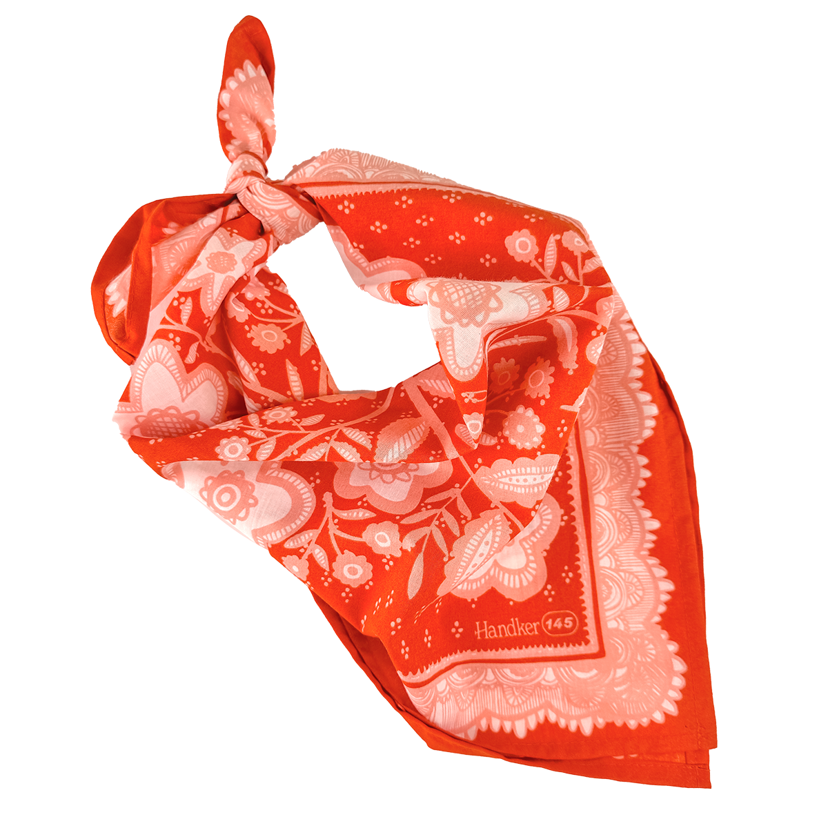 Red-orange and pink floral Lacey Bandana folded into a triangle and tied at the top.