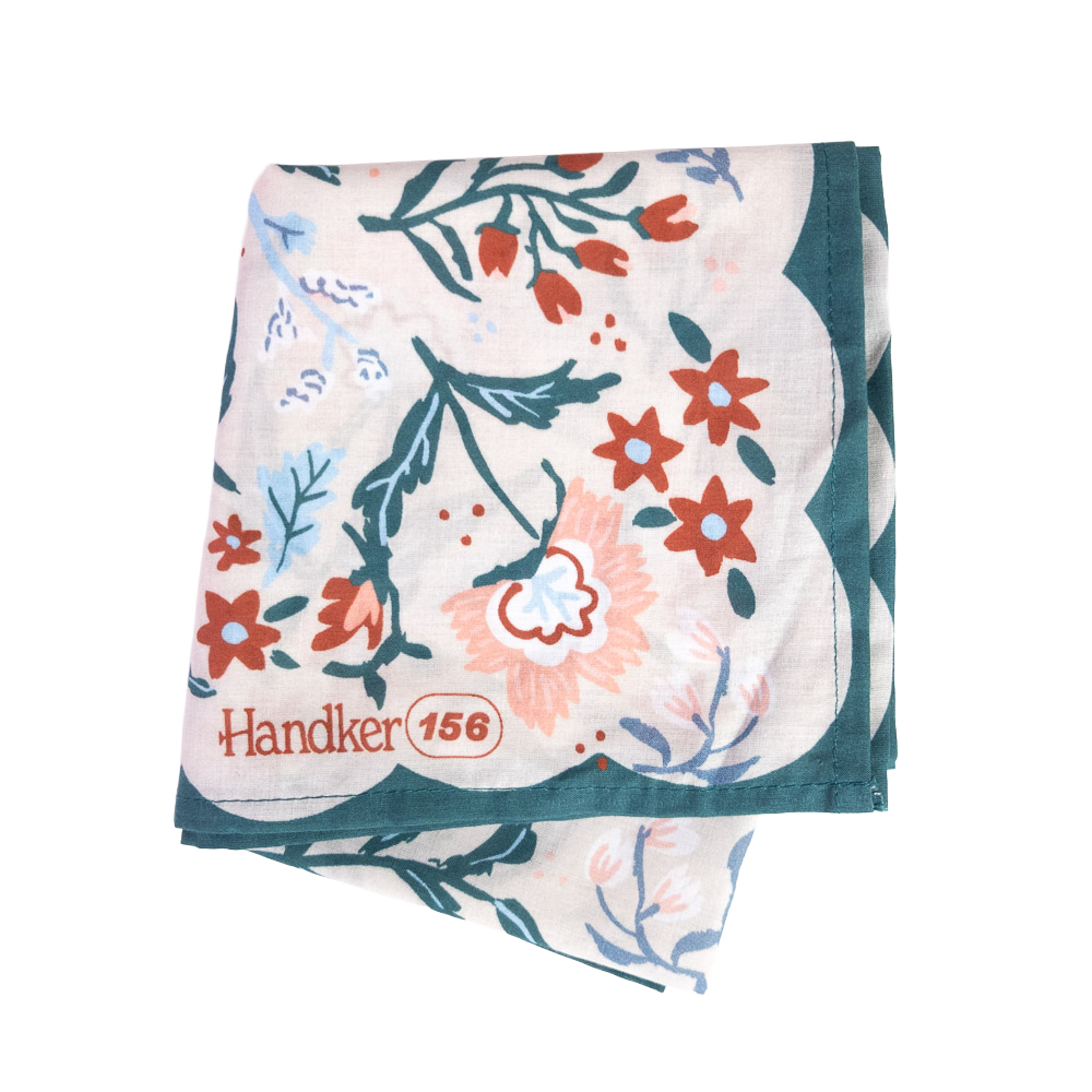 Folded No. 156 Willa Bandana showing its colorful botanical print and dark teal border.