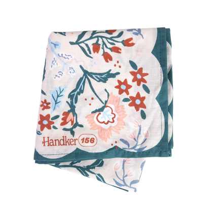 Folded No. 156 Willa Bandana showing its colorful botanical print and dark teal border.