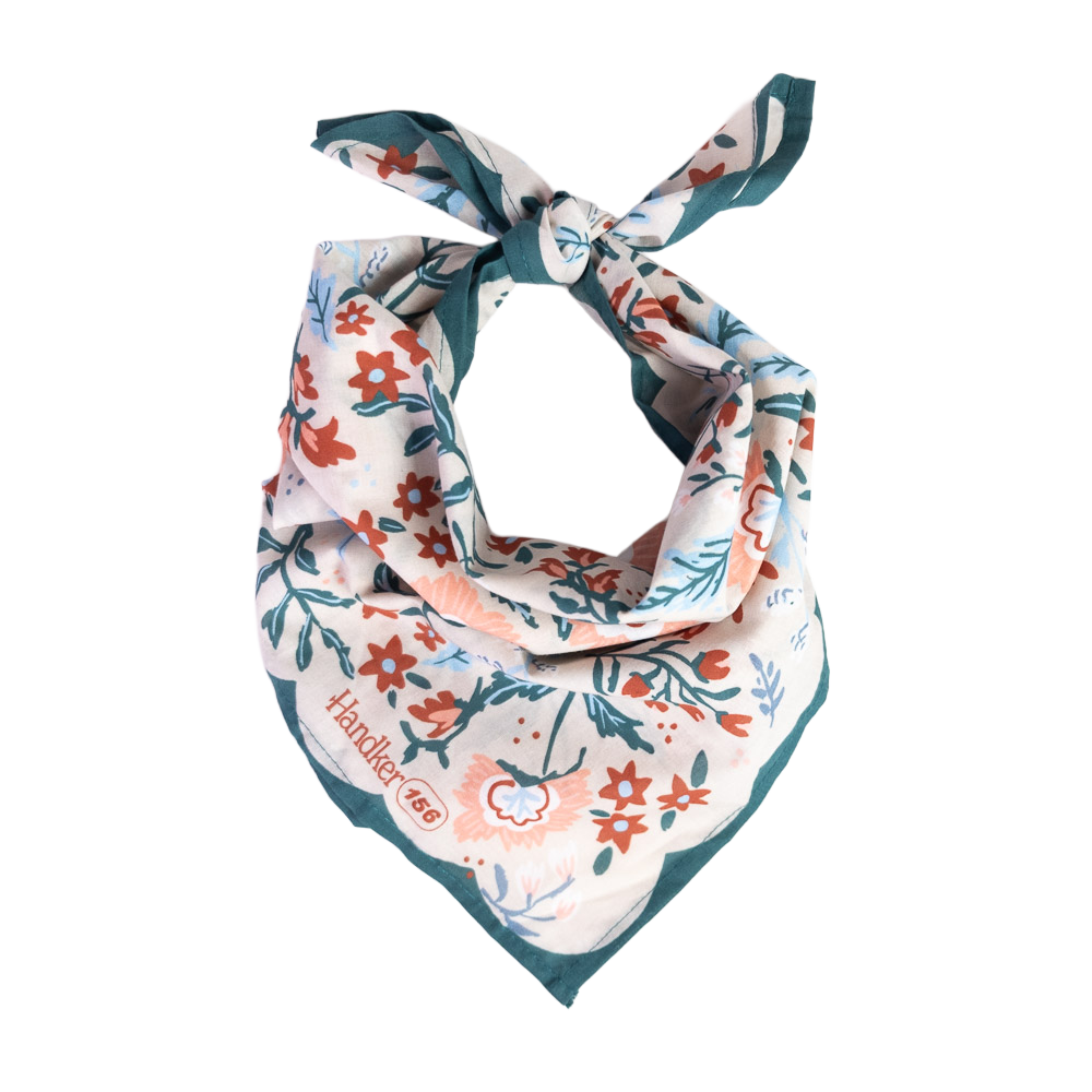 No. 156 Willa Bandana folded and tied to display its cream, teal, blue, and red floral pattern.