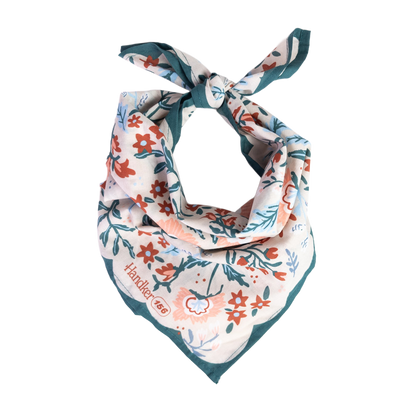 No. 156 Willa Bandana folded and tied to display its cream, teal, blue, and red floral pattern.