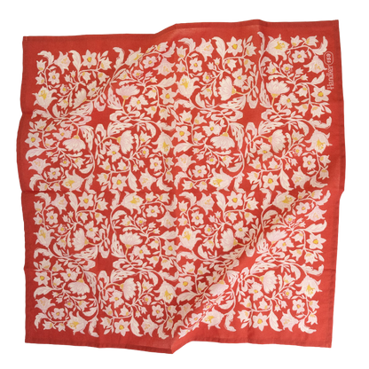 No. 159 Delphine Bandana laid flat with an intricate cream and ochre floral pattern on a poppy red background.