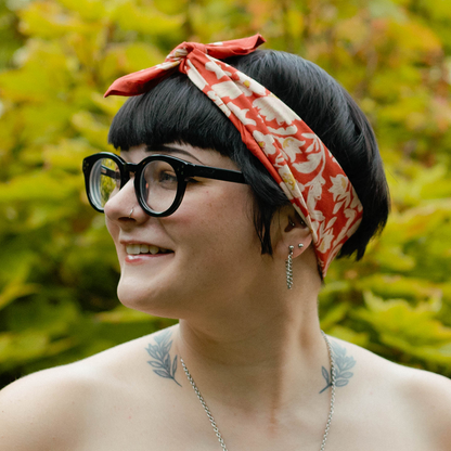 Front view of a woman wearing the No. 159 Delphine Bandana tied around her hair.
