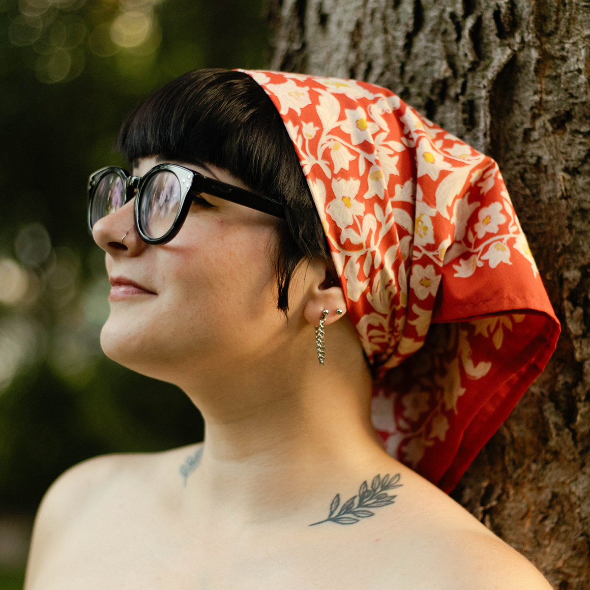 Side view of a woman wearing the No. 159 Delphine Bandana as a headscarf.