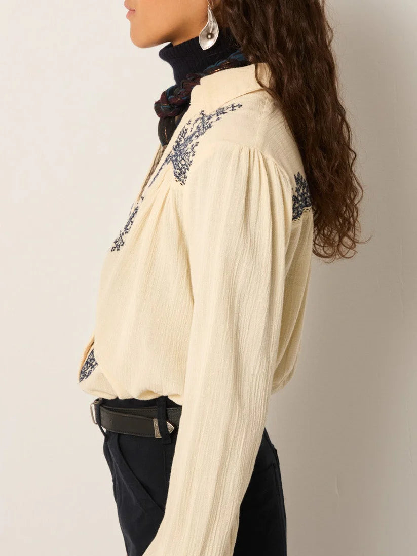 Side view of the Noida Amrit off-white embroidered shirt showing the relaxed fit, long sleeves, and navy detailing.
