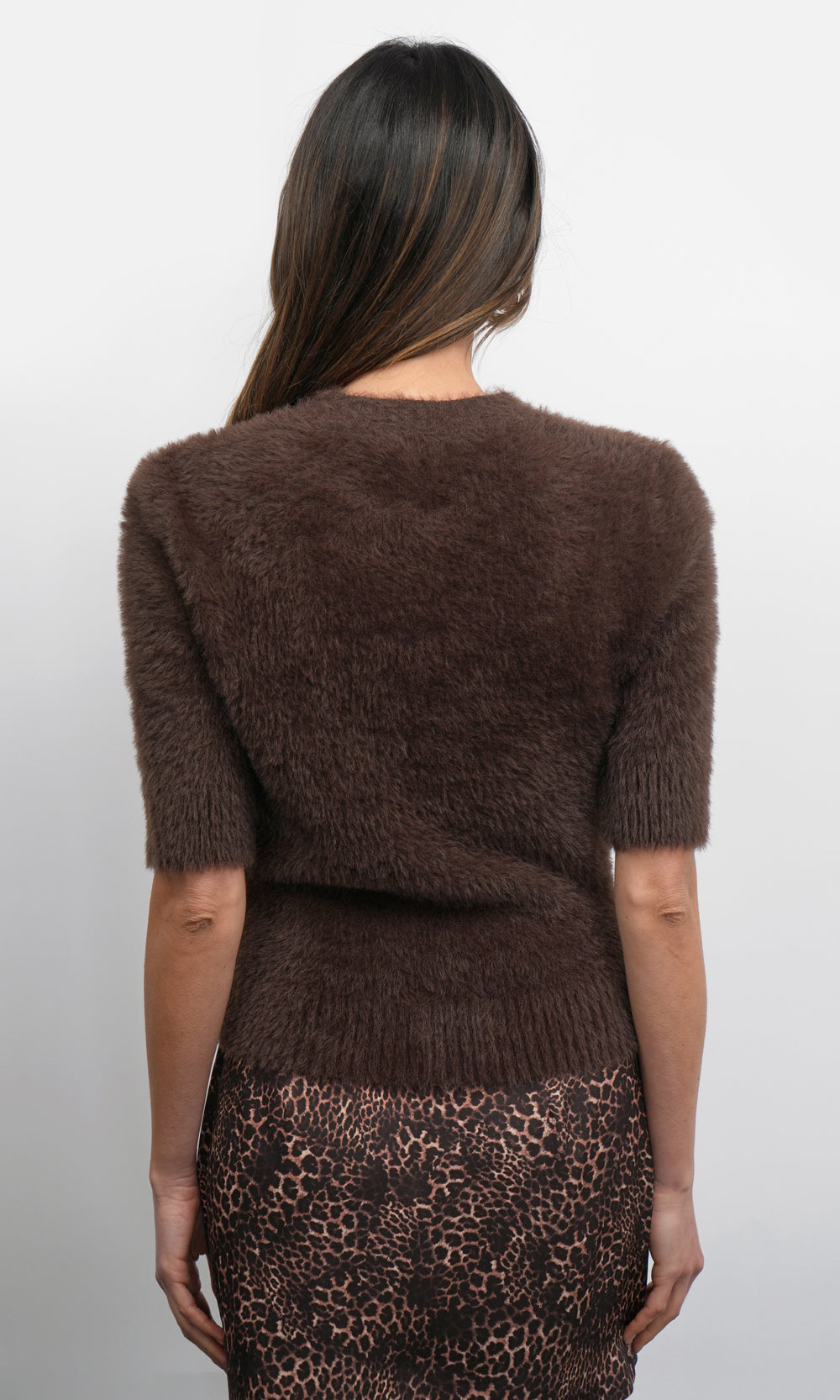 Back view of the Odette fuzzy knit top in dark brown featuring elbow-length sleeves, a fitted silhouette, and ribbed hem detailing.