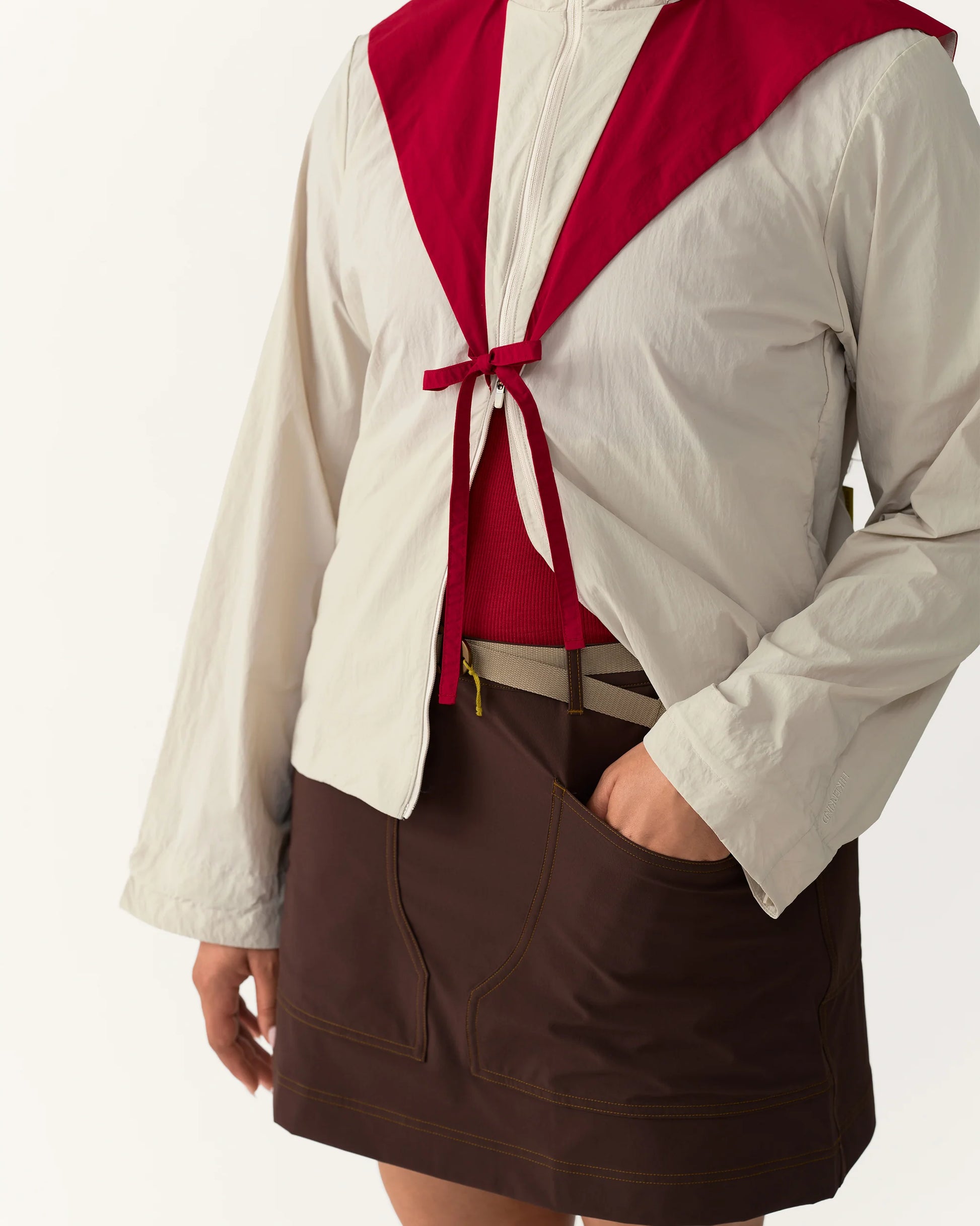 Close-up detail of Packable Windbreaker in Dolomite/Rowan showing front tie and zipper