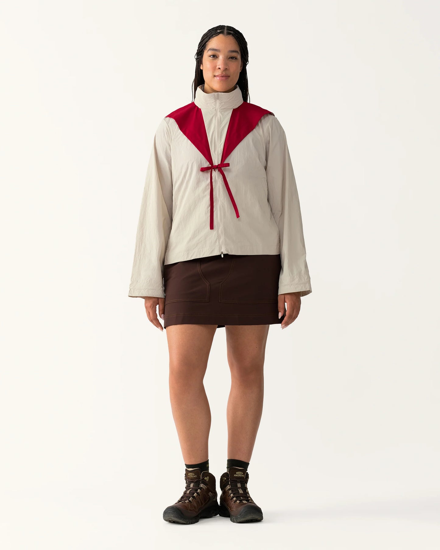 Full body view of Packable Windbreaker in Dolomite/Rowan styled with a skirt and boots