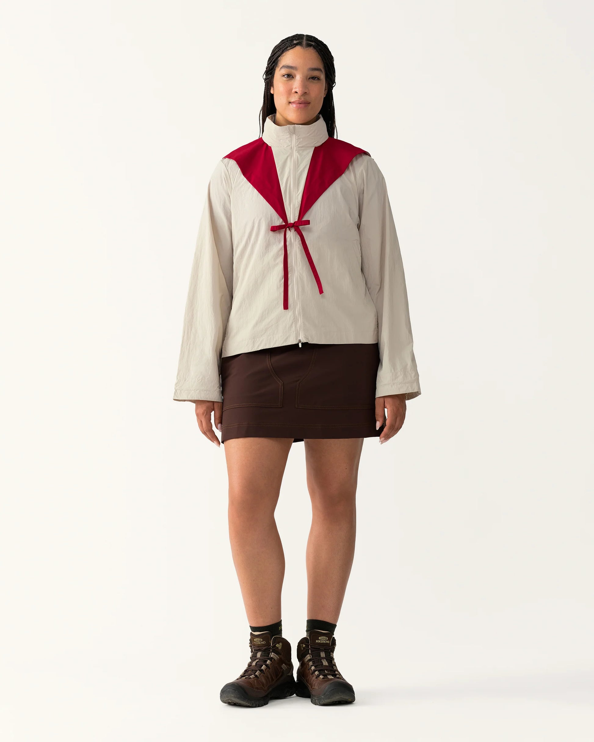 Full body view of Packable Windbreaker in Dolomite/Rowan styled with a skirt and boots