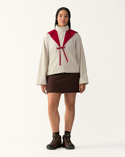 Full body view of Packable Windbreaker in Dolomite/Rowan styled with a skirt and boots