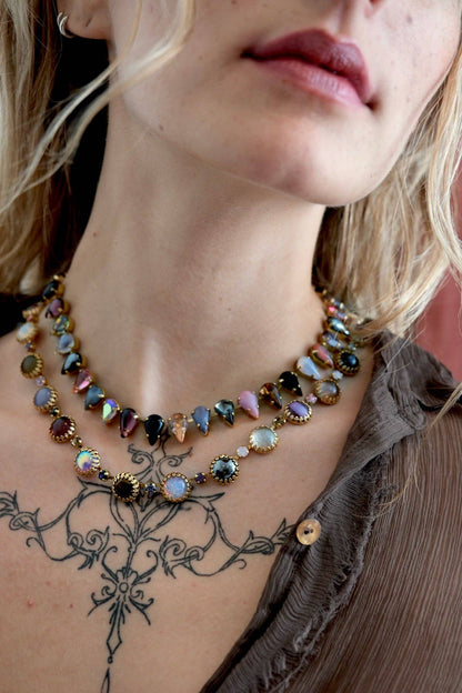 Close-up of the Paint Pot Layering Choker in Punk Rocks Gold styled with layered necklaces, featuring multicolor vintage glass stones and crystal accents.