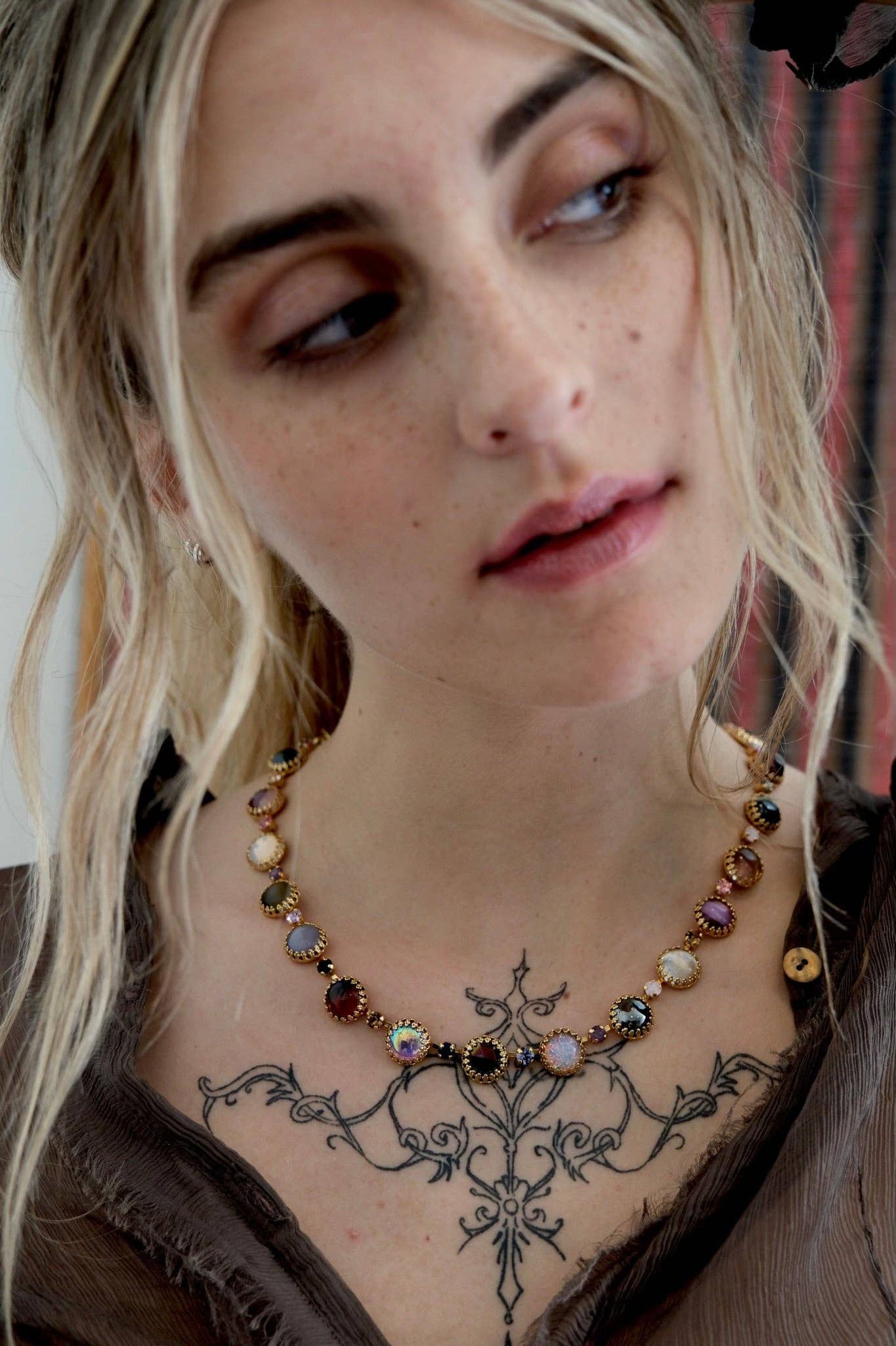 Model wearing the Paint Pot Layering Choker in Punk Rocks Gold layered with other necklaces for a colorful vintage-inspired look.