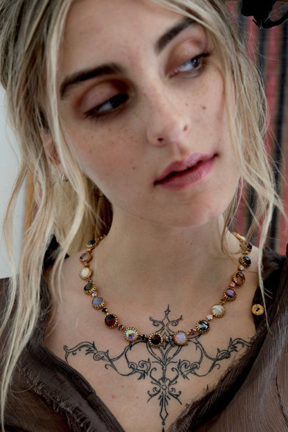 Model wearing the Paint Pot Layering Choker in Punk Rocks Gold layered with other necklaces for a colorful vintage-inspired look.