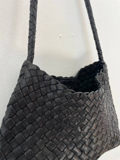 Side view of the Palar Black Bag showing its woven leather construction and relaxed shape