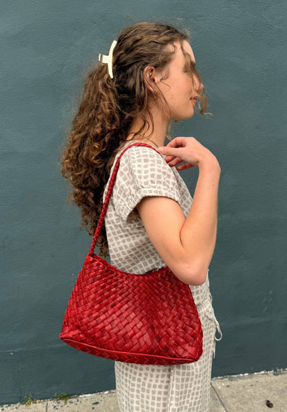 Woman wearing the handwoven Palar Red Bag over her shoulder