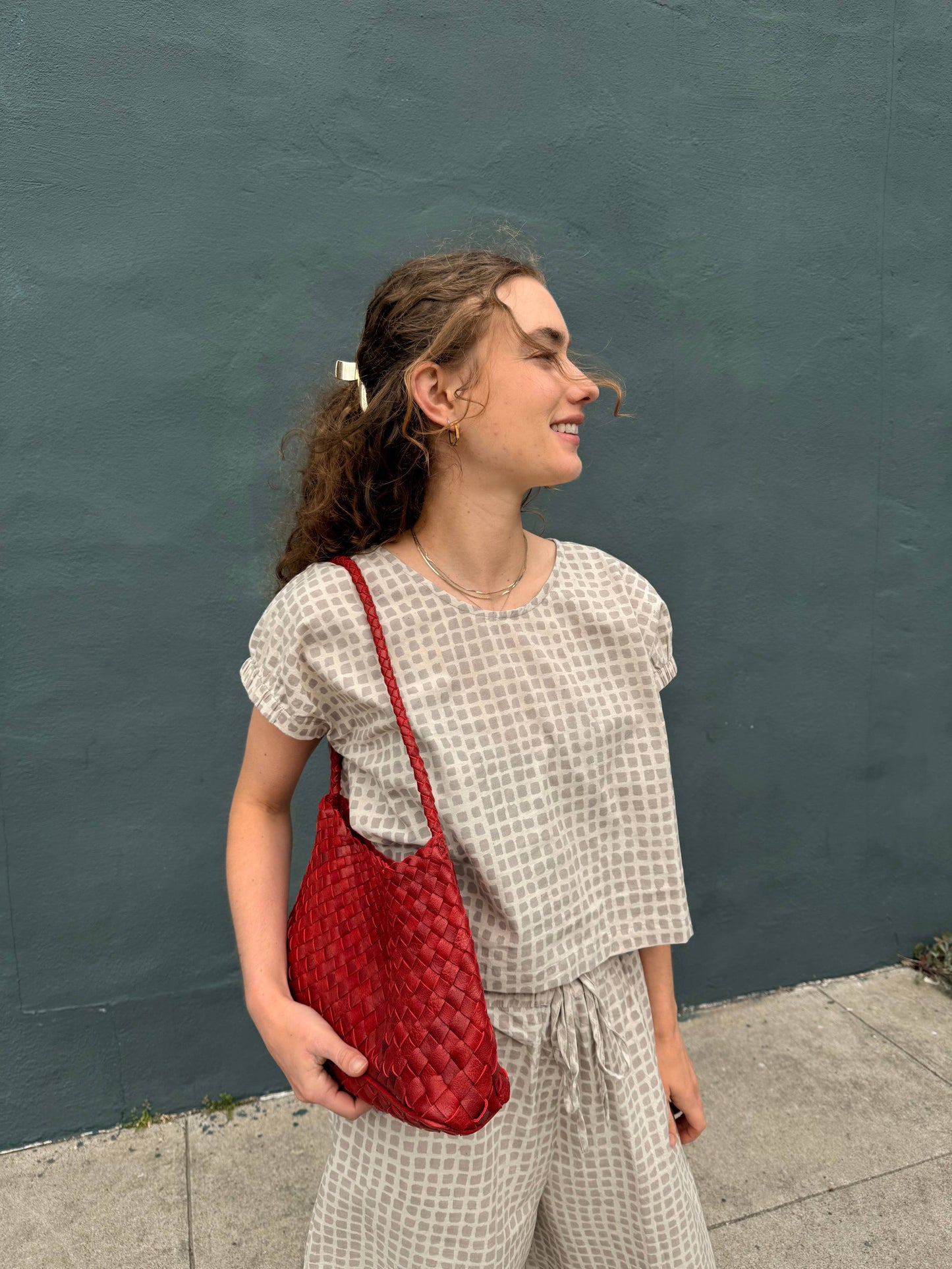Woman holding the Palar Red Bag at her side