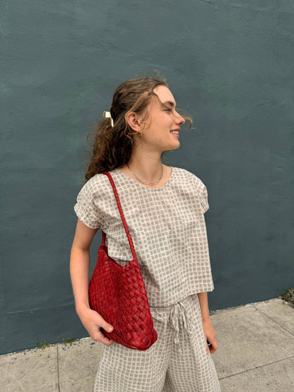 Woman holding the Palar Red Bag at her side