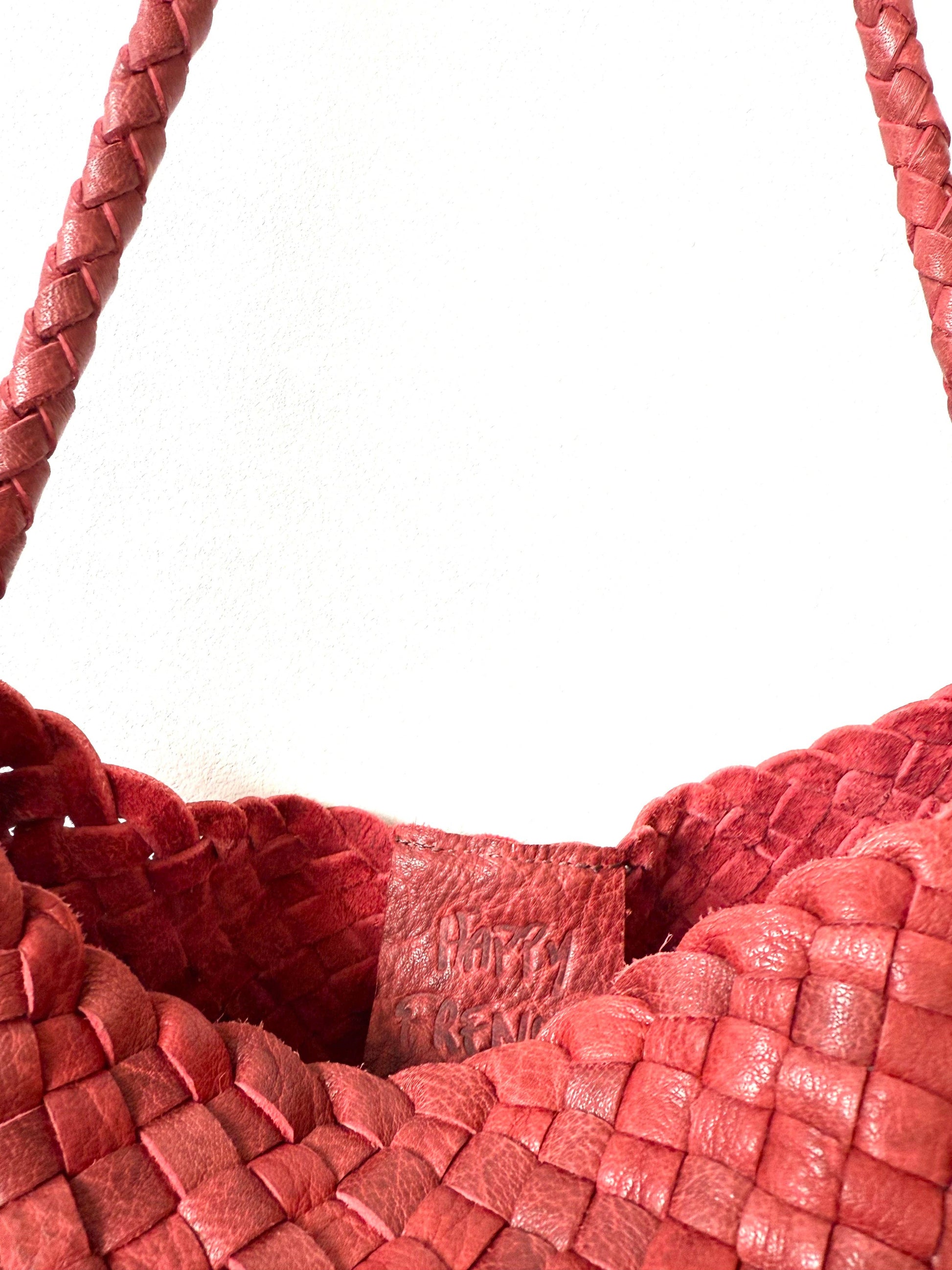 Close-up of the open top and woven leather texture of the Palar Red Bag