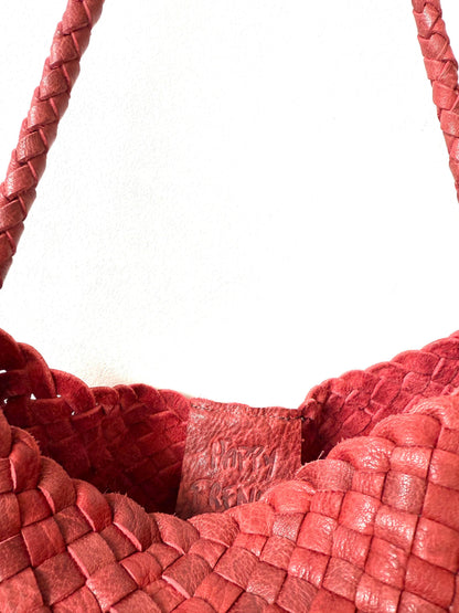 Close-up of the open top and woven leather texture of the Palar Red Bag