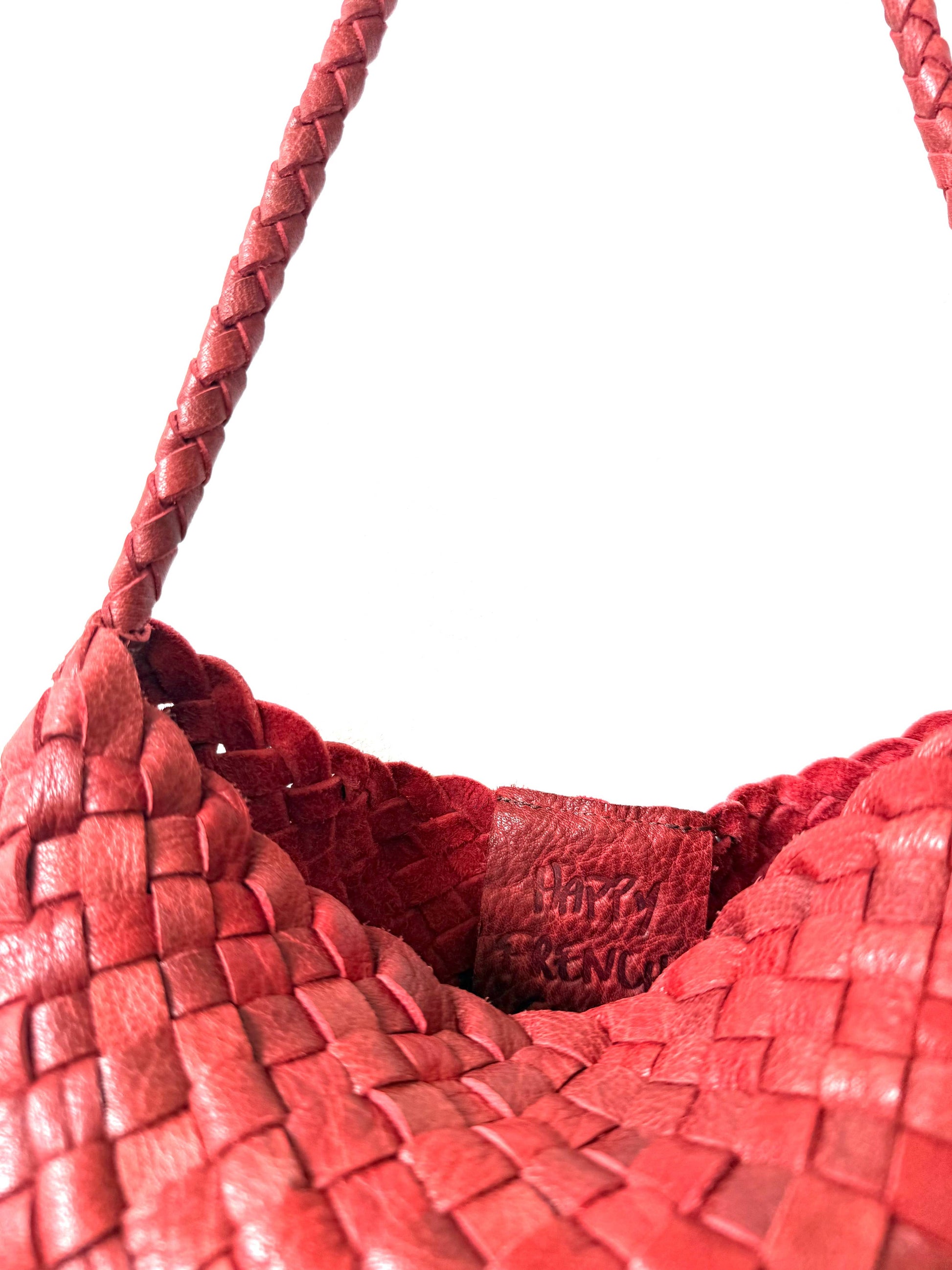 Close-up of the leather shoulder strap and open-top edge of the Palar Red Bag