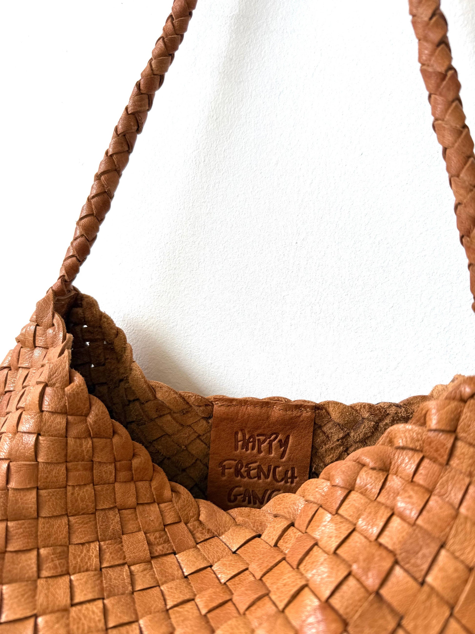 Close-up of the Palar Tan Bag open top, woven leather and interior brand label