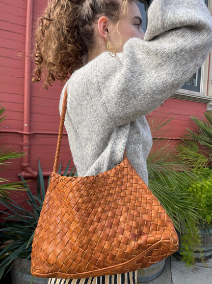 Model carrying the Palar Tan Bag over the shoulder with a grey sweater