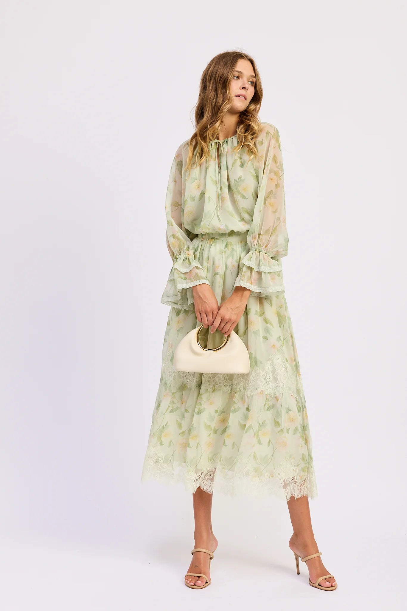 Model styling the Paloma Blouse with a matching floral midi skirt featuring lace trim, creating a soft romantic coordinated look.
