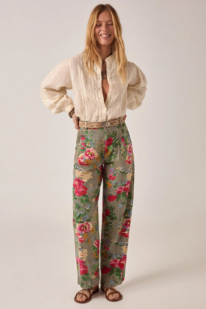 Full-length styling image of the Pepe Pant in Hulton Soul Noir featuring a high-rise waist, wide-leg silhouette, and expressive floral stripe print.