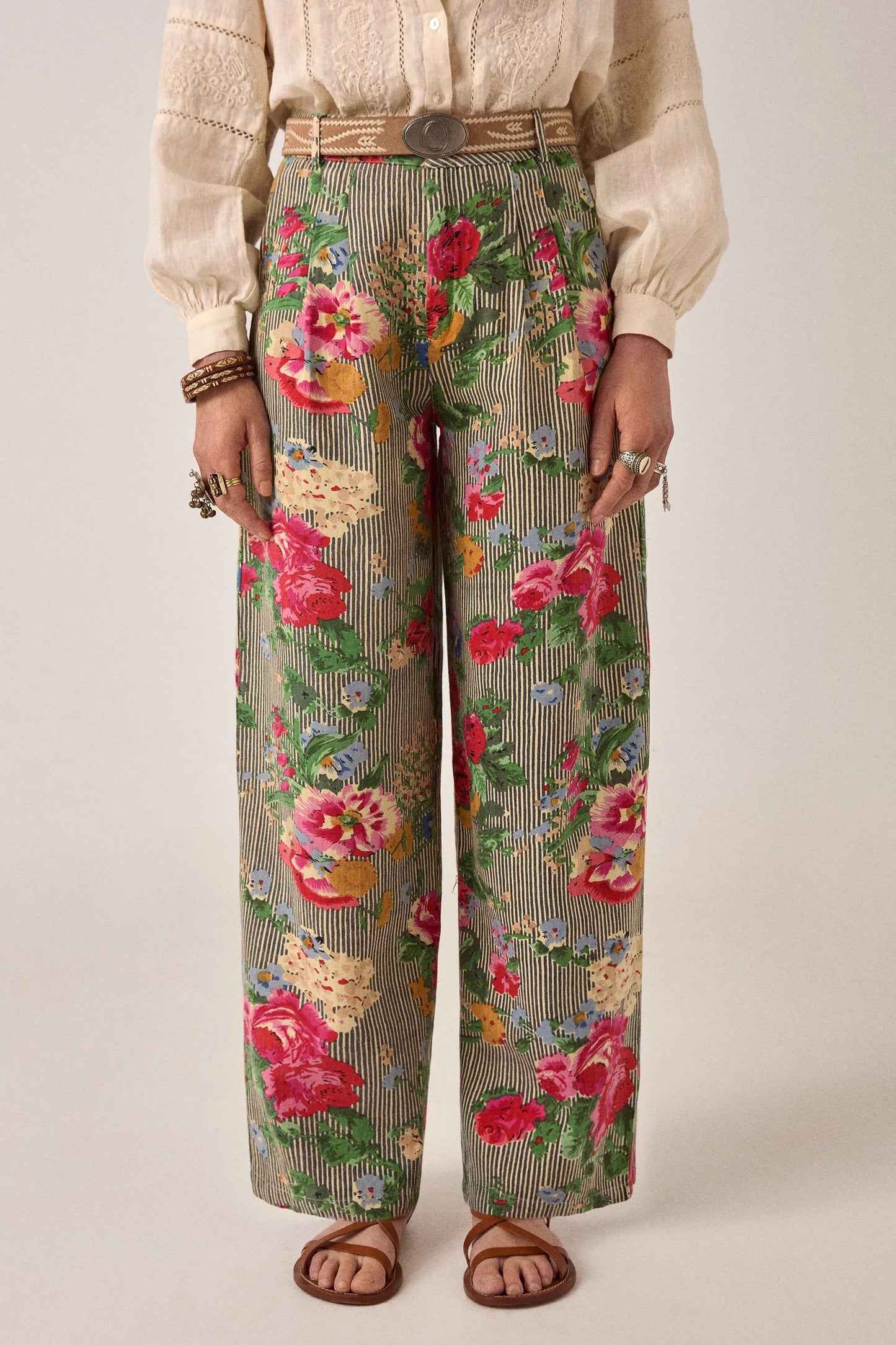Front view of Maison Hotel Pepe Pant in Hulton Soul Noir featuring vivid floral motifs over vertical striped cotton fabric with a high-rise wide-leg fit.