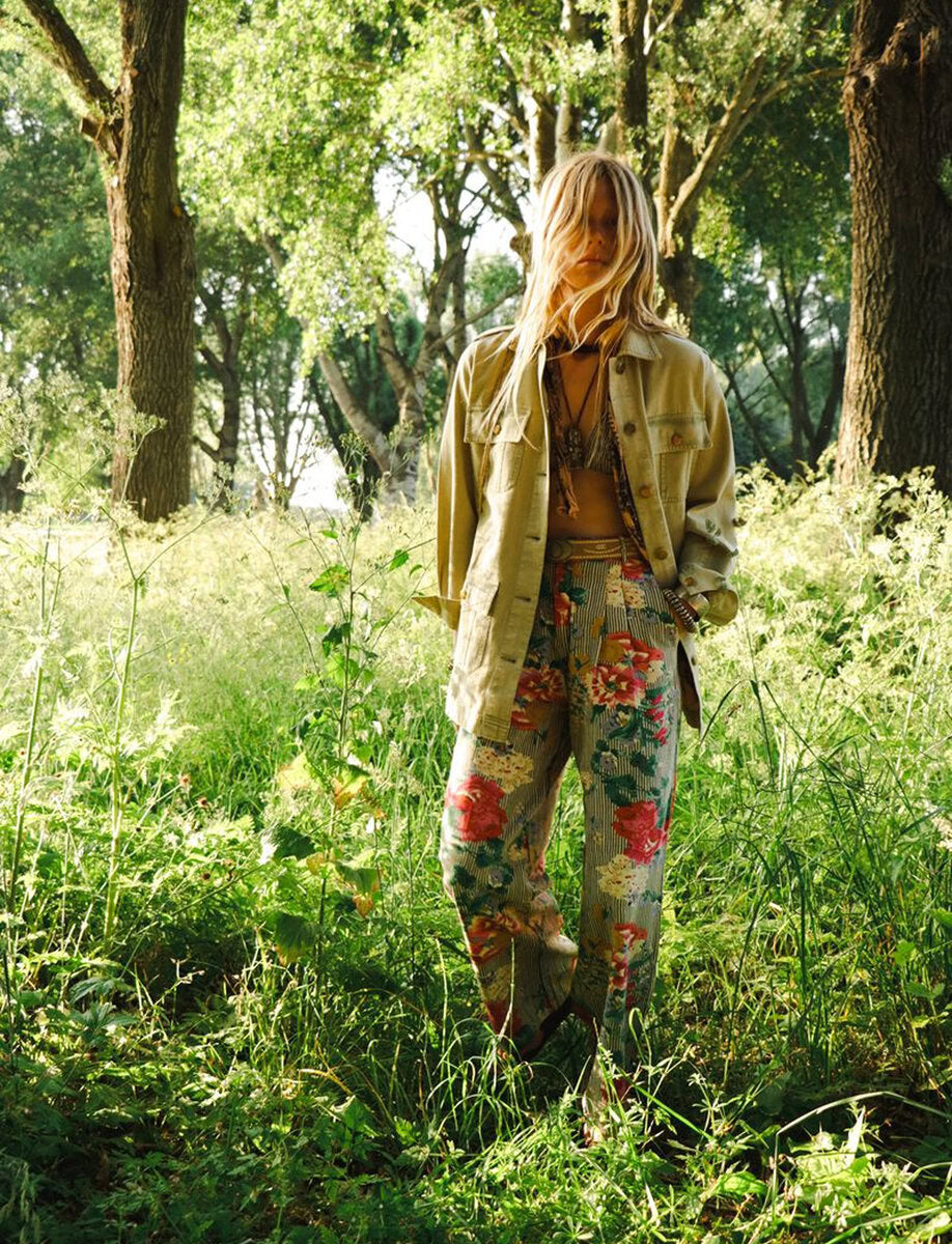 Model wearing Maison Hotel Pepe Pant in Hulton Soul Noir print featuring oversized florals layered over washed black stripes in a wide-leg cotton silhouette outdoors.