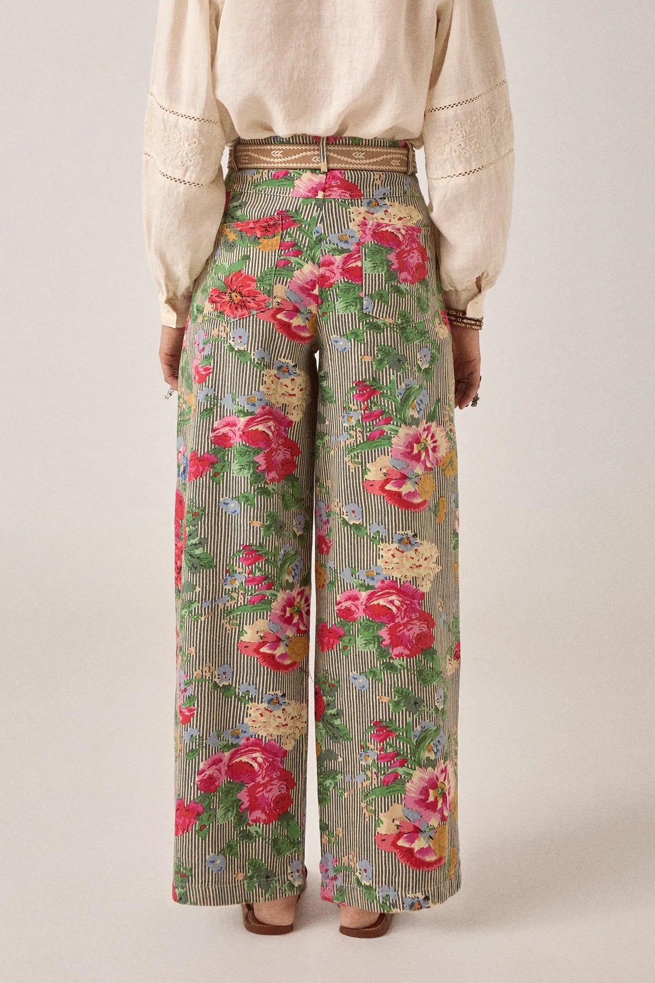 Back view of the Pepe Pant in Hulton Soul Noir featuring oversized floral artwork layered over striped cotton fabric with patch pockets and a wide-leg fit.