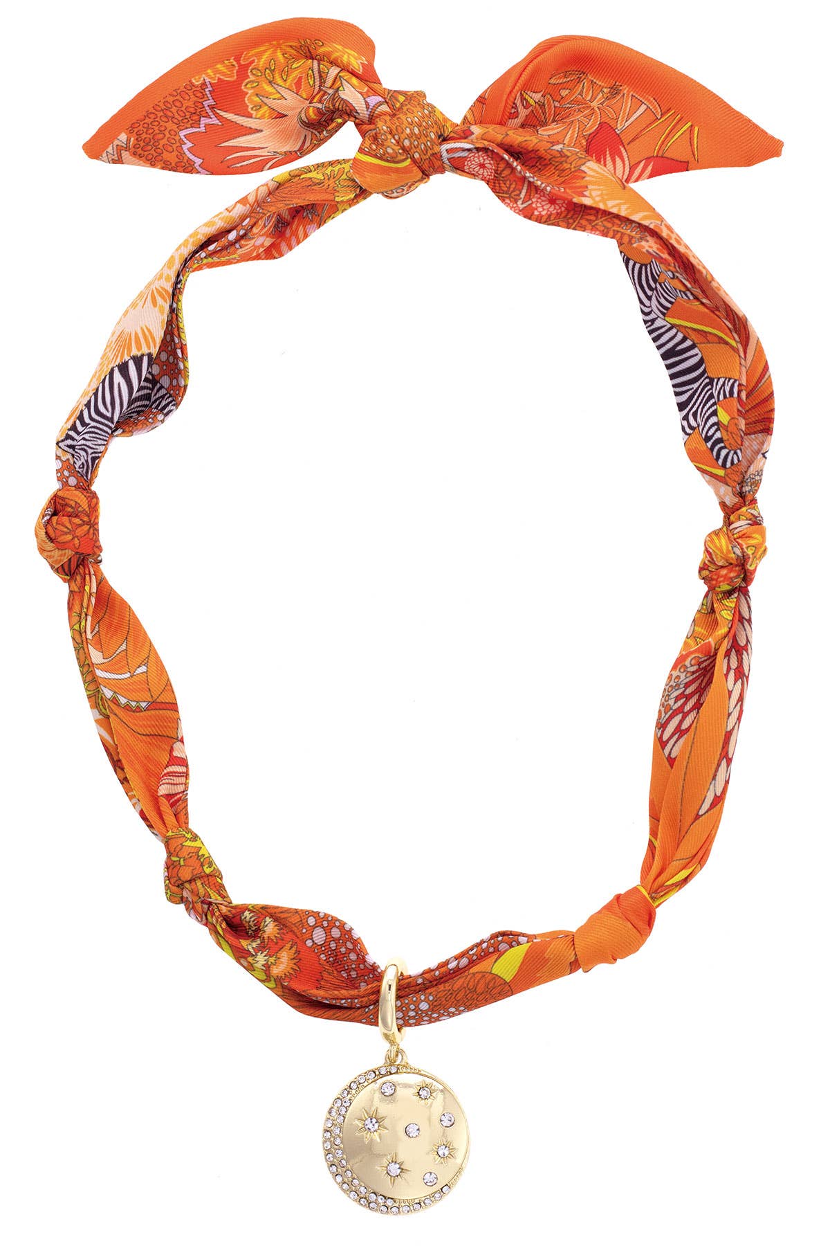 Orange and yellow patterned scarf necklace with knotted details and a sparkling celestial coin pendant on a white background.