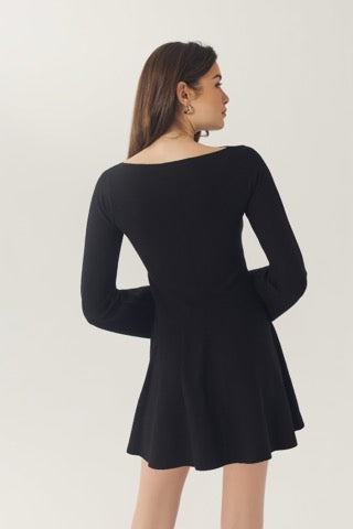 Back view of the black Prescott mini dress showing the wide neckline, fitted waist, and flared skirt.