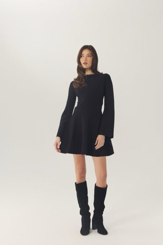 Full-length front view of the black Prescott dress styled with knee-high black boots.