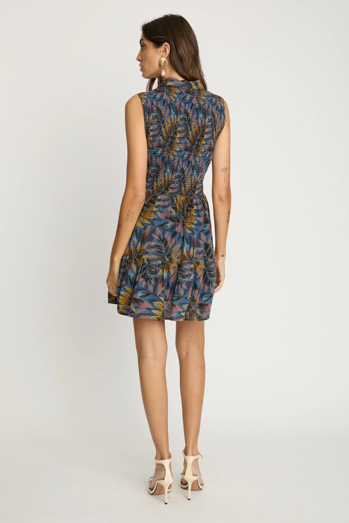Back view of the Prue Dress in Midnight Palm featuring the sleeveless design, smocked back waist, and softly gathered skirt.