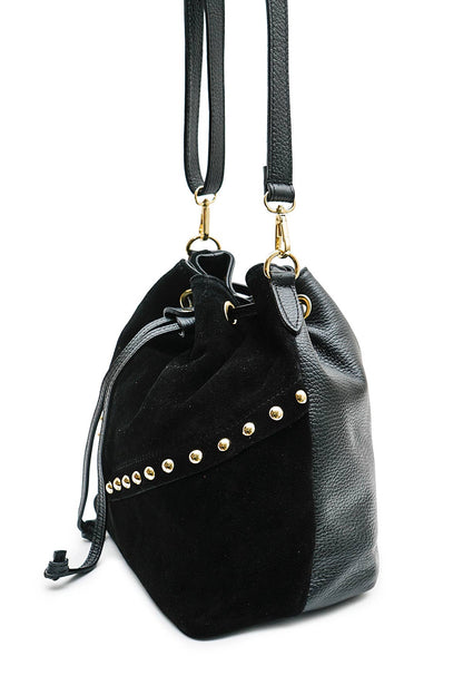 Side view of the Régine Suede Bag in black suede, showing the structured base, stud detailing, and leather strap attachments.
