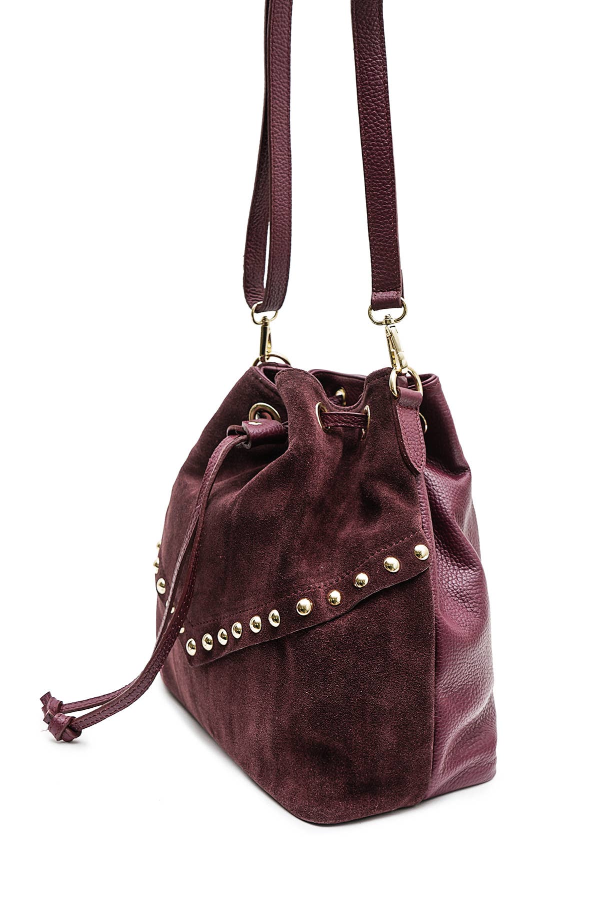 Angled view of the Régine Suede Bag in bordeaux suede showing the drawstring closure, leather trim, and stud details.