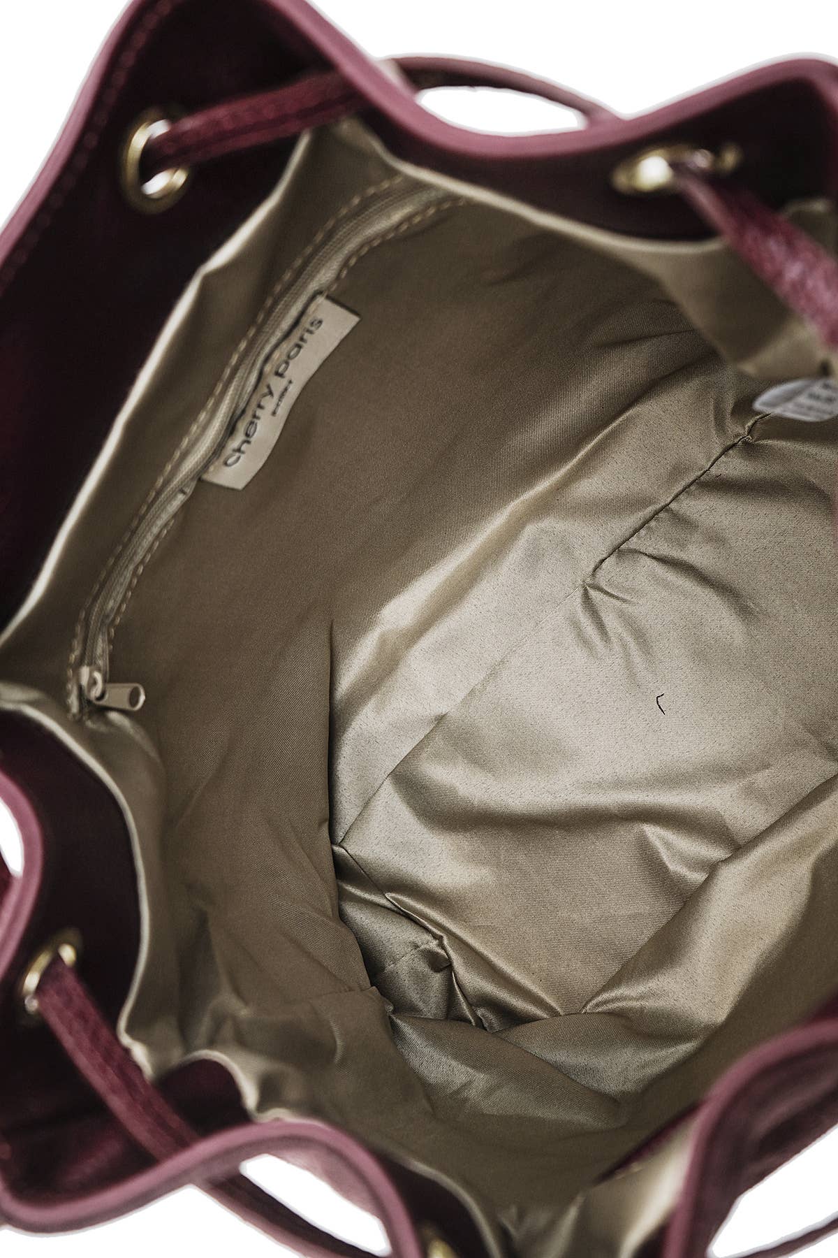 Interior of the Régine Suede Bag in bordeaux showing the lined compartment and interior pockets.