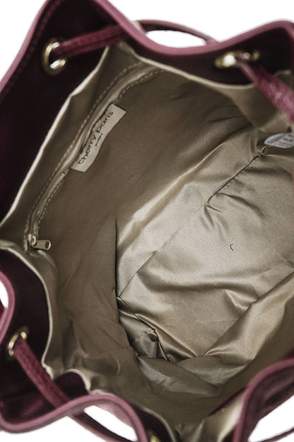 Interior of the Régine Suede Bag in bordeaux showing the lined compartment and interior pockets.
