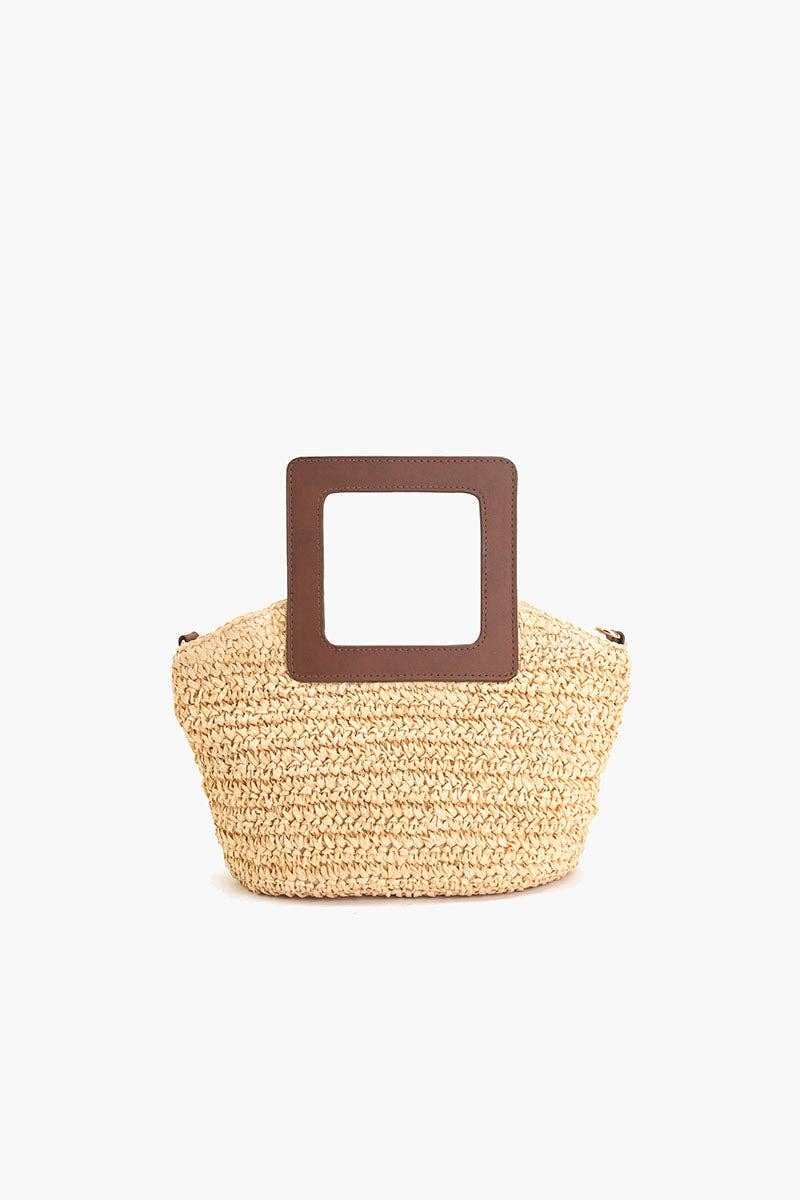 Back view of the woven beige raffia tote with a square brown cutout handle.